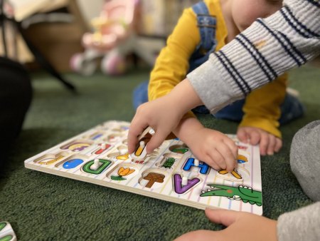 Kids playing with puzzle. 