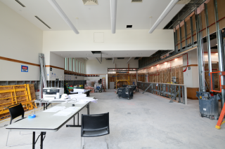 View of The Canvas looking east, August 2024 with framed walls, construction materials and concrete floor.