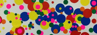 Close-up image of multicolored dot stickers on a giant letter
