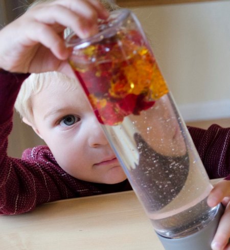 Child playing with sensory bottle