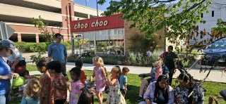 Children at story time in front of the Choo Choo restaurant. 