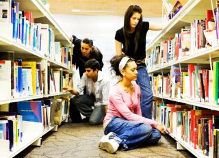 Teens in the library stacks.