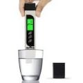 Digital Water Tester dipped in glass of water